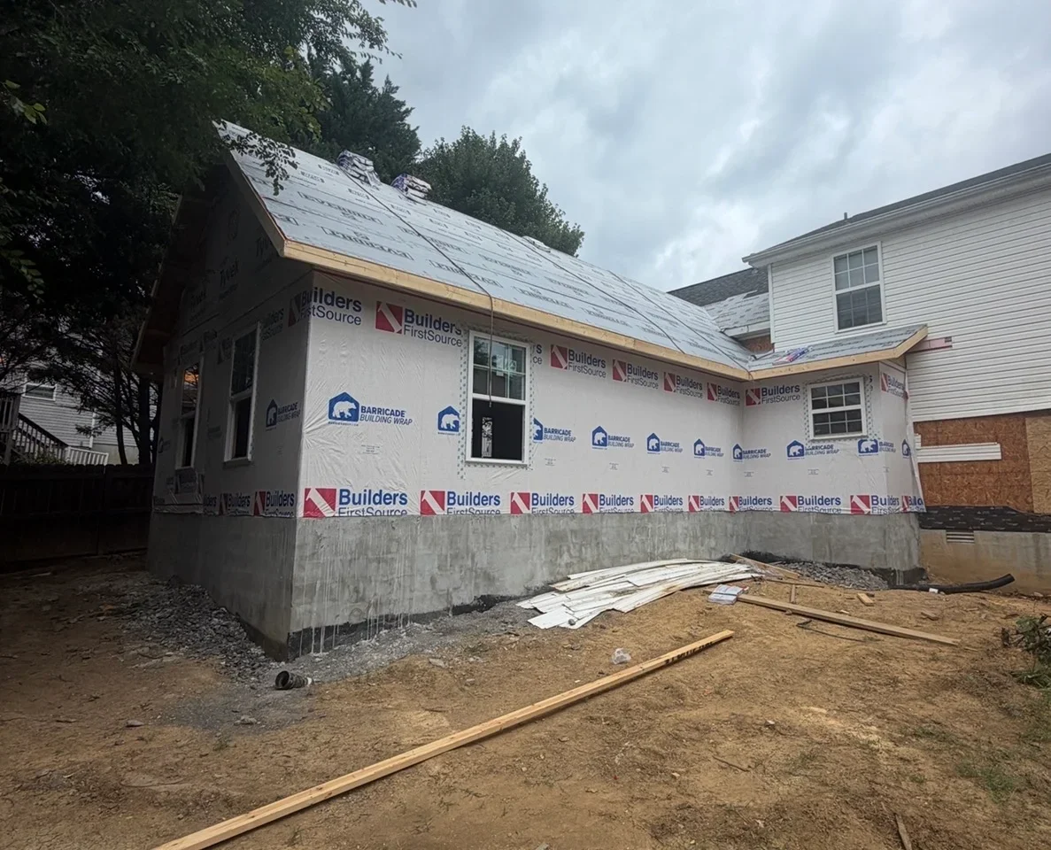 Single-story addition with Barricade building wrap, new windows, and roof underlayment over a concrete foundation